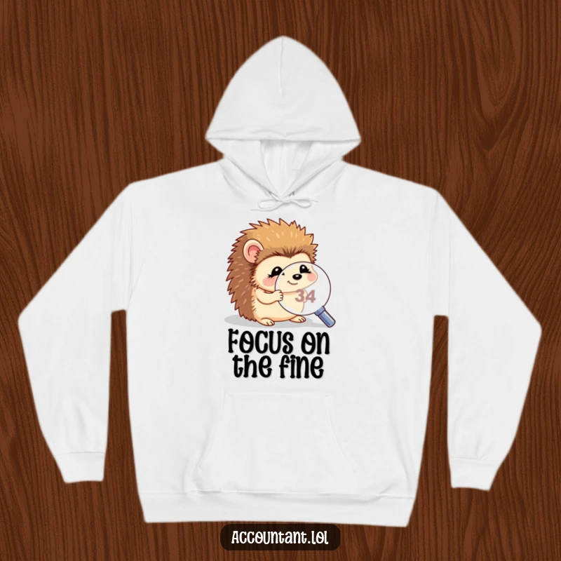Funny hedgehog magnifying hoodie, a soft sweatshirt showing a giggling hedgehog using a magnifying glass to examine a tiny number.