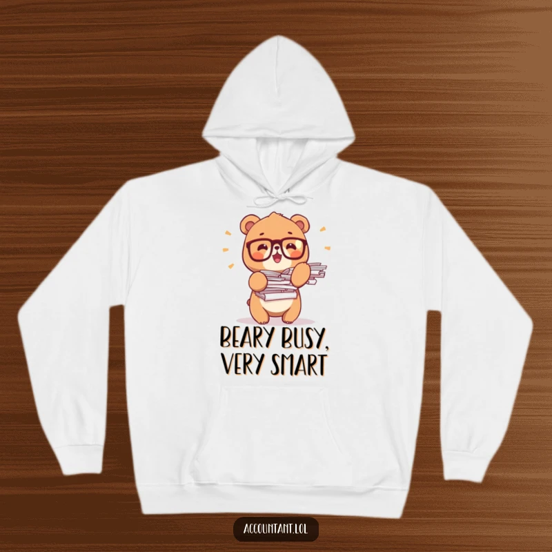 Funny bear office hoodie, a tiny bear sporting glasses, balancing large stacks of paper, exuding academic charm.