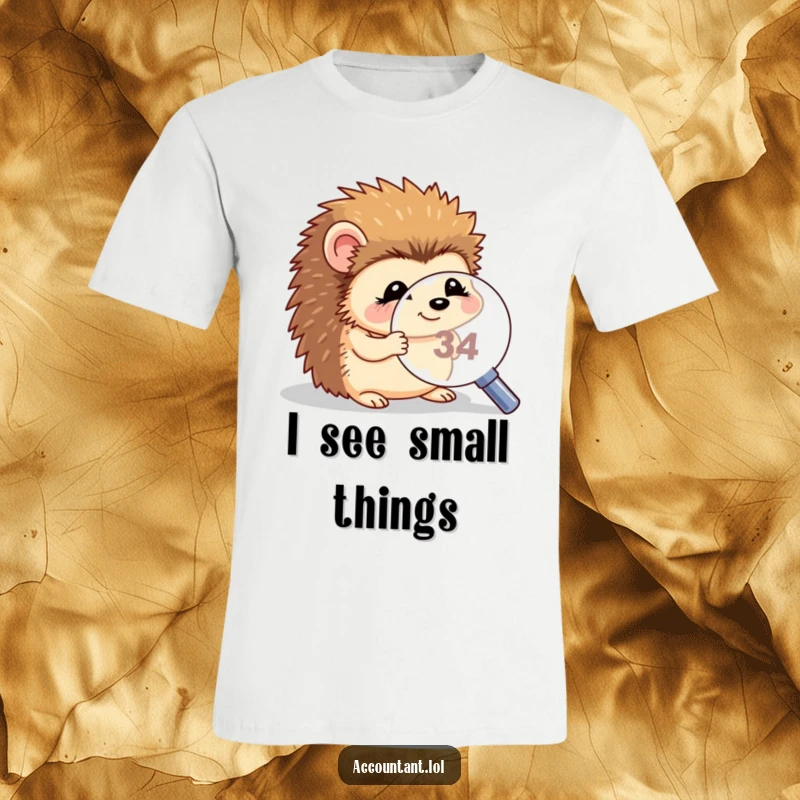 Funny hedgehog magnifying t-shirt, a giggling hedgehog looking intently through a magnifying glass at a very small number.